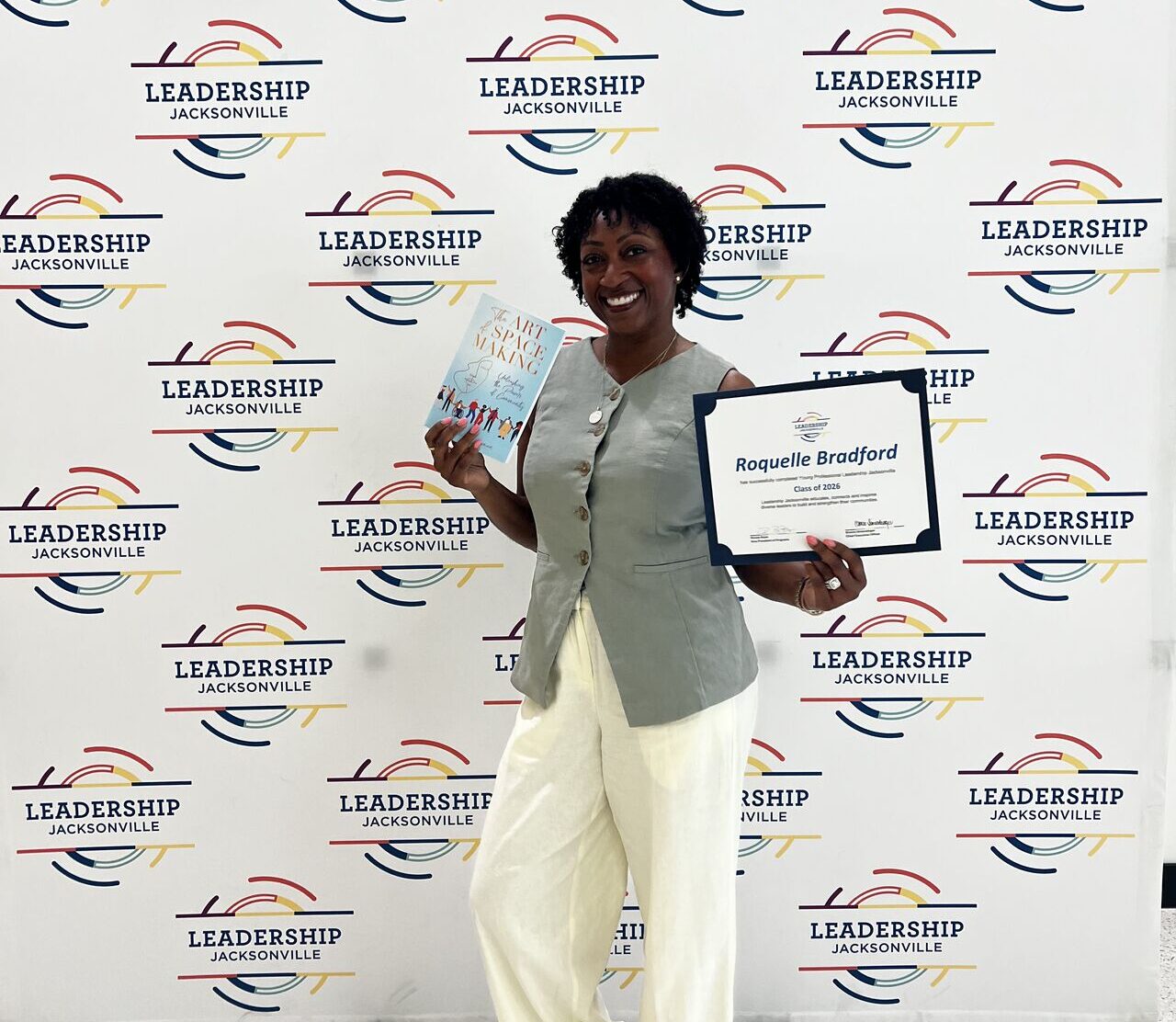 Roquelle Bradford Leadership Jacksonville graduate holding certificate at program completion event